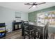 Dining room with a sleek black dining table set and gray-tone wood flooring at 1004 Peninsula Ave, Tarpon Springs, FL 34689