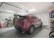 Organized garage space featuring a parked car, storage shelves and overhead lighting at 1004 Peninsula Ave, Tarpon Springs, FL 34689