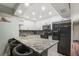 Kitchen with breakfast bar seating, stainless appliances, and modern finishes at 1004 Peninsula Ave, Tarpon Springs, FL 34689