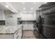 Bright kitchen features granite counters, stainless appliances and white cabinets at 1004 Peninsula Ave, Tarpon Springs, FL 34689