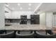 Kitchen showcasing a granite-topped island, stainless appliances, and sleek white cabinetry at 1004 Peninsula Ave, Tarpon Springs, FL 34689