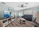 Comfortable living room featuring wood flooring, a ceiling fan, and access to adjacent rooms at 1004 Peninsula Ave, Tarpon Springs, FL 34689