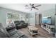 Inviting living room featuring comfortable seating, wood flooring, and a ceiling fan at 1004 Peninsula Ave, Tarpon Springs, FL 34689
