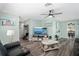 Spacious living room with wood flooring, a ceiling fan, and open access to other spaces at 1004 Peninsula Ave, Tarpon Springs, FL 34689