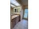 Bright bathroom with vanity, tile flooring and access to exterior at 10054 Hernando Ridge Rd, Weeki Wachee, FL 34613