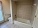 Tiled bathroom featuring a tub and door to the exterior at 10054 Hernando Ridge Rd, Weeki Wachee, FL 34613