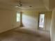 Bright, carpeted bedroom with natural light from the window and a glass door to the patio at 10054 Hernando Ridge Rd, Weeki Wachee, FL 34613