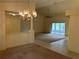 Dining area featuring decorative chandelier lighting, neutral walls, view to other areas of the home, and view to porch at 10054 Hernando Ridge Rd, Weeki Wachee, FL 34613
