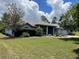 Charming single-story home featuring a well-manicured lawn, mature landscaping, and a welcoming front entrance at 10054 Hernando Ridge Rd, Weeki Wachee, FL 34613