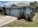 Charming home exterior showcasing blue siding and a gray garage door at 10054 Hernando Ridge Rd, Weeki Wachee, FL 34613