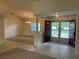 Spacious foyer with tile flooring leading into a living area with a chandelier and bright windows at 10054 Hernando Ridge Rd, Weeki Wachee, FL 34613