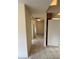 Neutral hallway showing tile flooring leading to the carpeted bedrooms at 10054 Hernando Ridge Rd, Weeki Wachee, FL 34613