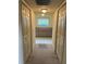 Hallway featuring linen closet and storage cabinets at the end of the hall with glass block window at 10054 Hernando Ridge Rd, Weeki Wachee, FL 34613