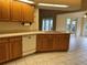 This large kitchen is fitted with light-stained wood cabinets and features tile flooring at 10054 Hernando Ridge Rd, Weeki Wachee, FL 34613
