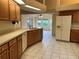 Spacious kitchen boasts a tile floor, classic cabinets, and modern appliances overlooking the light filled living space at 10054 Hernando Ridge Rd, Weeki Wachee, FL 34613