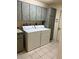 The laundry room features built-in cabinets, a utility sink, and a full-size washer and dryer at 10054 Hernando Ridge Rd, Weeki Wachee, FL 34613