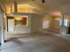 Open concept living space with high ceilings, a bar-style counter to the kitchen, and neutral carpet at 10054 Hernando Ridge Rd, Weeki Wachee, FL 34613