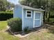 Well maintained blue shed with white trim in backyard at 10054 Hernando Ridge Rd, Weeki Wachee, FL 34613