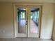 A clear view of the sunroom with beautiful flooring through double glass doors at 10054 Hernando Ridge Rd, Weeki Wachee, FL 34613