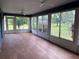 A sunroom with many windows providing plenty of natural light and scenic outdoor views at 10054 Hernando Ridge Rd, Weeki Wachee, FL 34613