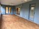 This spacious sunroom features wood laminate flooring, plenty of windows, and great natural light at 10054 Hernando Ridge Rd, Weeki Wachee, FL 34613