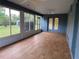 Bright sunroom features wood laminate floors, and views of the surrounding landscaped yard at 10054 Hernando Ridge Rd, Weeki Wachee, FL 34613