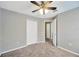 Spare bedroom with neutral walls, a ceiling fan, and view of two closets at 1009 Summer Breeze Dr, Brandon, FL 33511