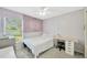Bright bedroom featuring neutral walls, carpet flooring, and a study corner with a modern desk at 1009 Summer Breeze Dr, Brandon, FL 33511