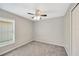 Neutral bedroom offers a ceiling fan and natural light from a window at 1009 Summer Breeze Dr, Brandon, FL 33511