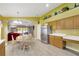 Open concept kitchen features stainless steel appliances, wood cabinets, and eat-in dining space at 1009 Summer Breeze Dr, Brandon, FL 33511