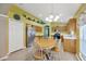 Eat-in kitchen features stainless steel refrigerator, light wood cabinets, and laminate wood floor at 1009 Summer Breeze Dr, Brandon, FL 33511