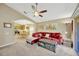 Open-concept living room with a plush sofa, adjacent kitchen, and access to the outdoor patio at 1009 Summer Breeze Dr, Brandon, FL 33511