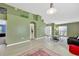 Open-concept living room features hardwood flooring, large windows, neutral colored walls, and an open floor plan at 1009 Summer Breeze Dr, Brandon, FL 33511