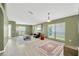 Bright living room with neutral flooring, large windows, and stylish contemporary furnishings with decorative rugs at 1009 Summer Breeze Dr, Brandon, FL 33511