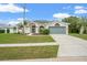 Beautiful single-story home showcasing unique architectural details and a well-maintained yard at 1010 Archway Dr, Spring Hill, FL 34608