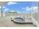 Inviting screened lanai featuring a relaxing hot tub with charming tile accents and ample lounging space at 1010 Archway Dr, Spring Hill, FL 34608