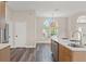 Modern kitchen featuring wood cabinets, stainless steel appliances, and an elegant light fixture above the island at 1010 Archway Dr, Spring Hill, FL 34608