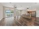 Open-concept living space featuring modern finishes, wood floors, natural light, and access to the outdoor patio at 1010 Archway Dr, Spring Hill, FL 34608
