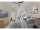 Cozy main bedroom features a mounted television and decor art on the wall at 1010 Archway Dr, Spring Hill, FL 34608