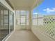 Enclosed porch with screened lattice accents and sliding glass door providing seamless indoor-outdoor flow at 1010 Archway Dr, Spring Hill, FL 34608