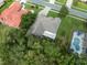 Overhead neighborhood view with tree coverage, landscaping, and nearby pool at 10296 Palmgren, Spring Hill, FL 34608