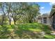 A spacious yard with mature trees creates a calming natural atmosphere around the home at 10296 Palmgren, Spring Hill, FL 34608