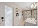Bright bathroom with a white vanity, patterned shower curtain, and natural light at 10296 Palmgren, Spring Hill, FL 34608