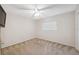 Cozy bedroom featuring neutral tones, plush carpeting, and a ceiling fan at 10296 Palmgren, Spring Hill, FL 34608