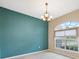 Cozy dining room area featuring a modern chandelier and large window at 10296 Palmgren, Spring Hill, FL 34608