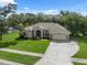 Well-maintained home with a manicured lawn, beautiful landscaping, and inviting curb appeal at 10296 Palmgren, Spring Hill, FL 34608