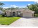 Lovely single Gathering home featuring an attached two car garage and a well-kept lawn at 10296 Palmgren, Spring Hill, FL 34608