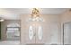 Welcoming foyer with decorative light fixture and stylish double entry doors at 10296 Palmgren, Spring Hill, FL 34608