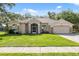 Charming single-story home featuring a well-manicured lawn and inviting facade at 10296 Palmgren, Spring Hill, FL 34608