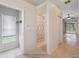 Hallway featuring a walk-in shower, closets, and tile flooring at 10296 Palmgren, Spring Hill, FL 34608
